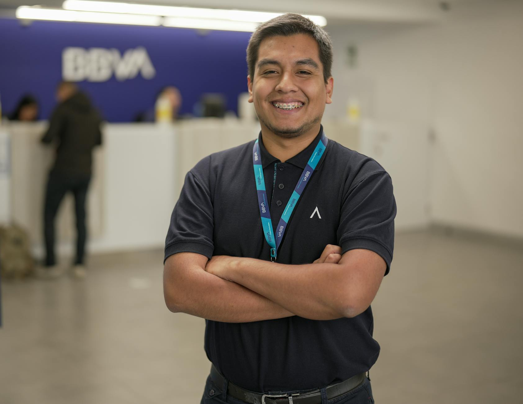smiling bank employee at bbva reception desk